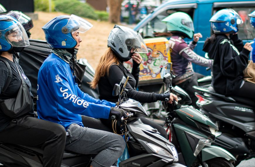 Motorcycle taxis squeeze through gaps in public transport